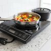 Induction cooktop on kitchen counter with pots