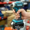 Makita XDT19Z 18V compact impact driver held in hand showing ergonomic grip and 1 by 4-inch hex chuck