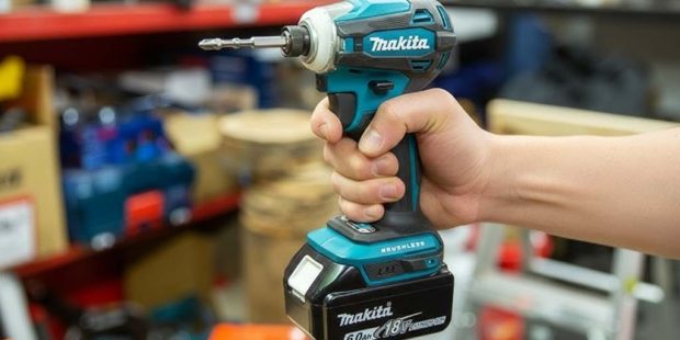 Makita XDT19Z 18V compact impact driver held in hand showing ergonomic grip and 1 by 4-inch hex chuck