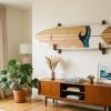 Modern surfboard mounted securely on a living room wall rack.