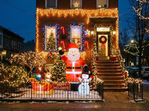 Decorated Brooklyn house with holiday lights and inflatable Santa display
