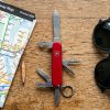 Red Swiss Army Knife resting on a New York City subway map.