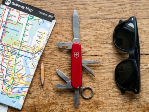 Red Swiss Army Knife resting on a New York City subway map.