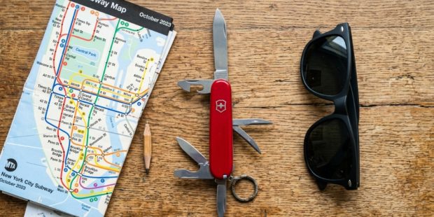 Red Swiss Army Knife resting on a New York City subway map.