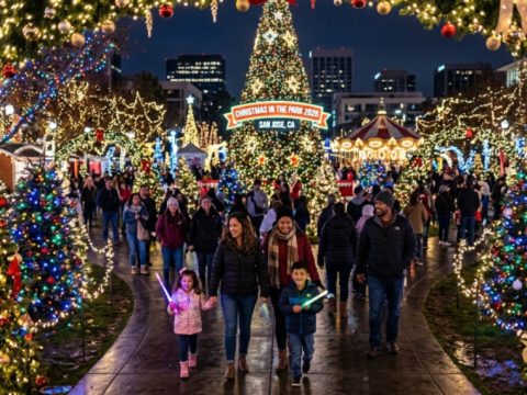 Families walking through thousands of glittering holiday lights and decorated trees at Christmas in the Park 2026 at Plaza de Cesar Chavez in downtown San Jose, California