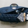 Golf travel bag laid out with cleaning supplies.