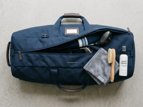 Golf travel bag laid out with cleaning supplies.