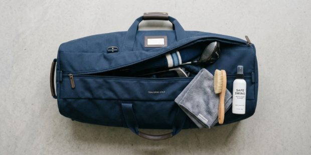Golf travel bag laid out with cleaning supplies.