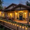 Solar Christmas lanterns illuminating a California home's front porch at night.